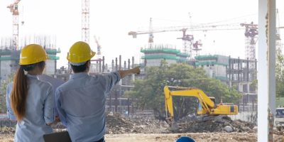 engineer-group-and-worker-meeting-discussion-with-construction-blueprint-on-site-work-and-point-finger-to-the-work-site