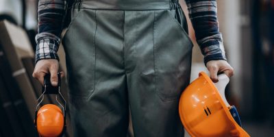 young-male-handyman-with-safety-earphones-scaled-1